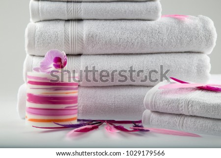 towel on the white background with candle and feather