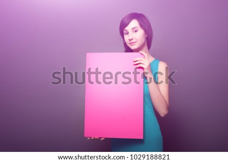 woman holding pink banner. Portrait of isolated black background. Young teenage girl