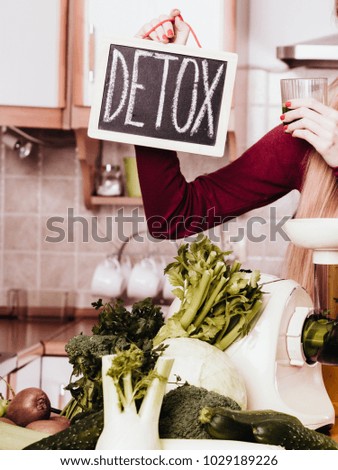 Dieting and detoxing, weight loss concept. Woman holding board with detox sign