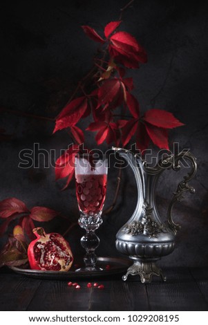 Still life with red wine and pomegranate