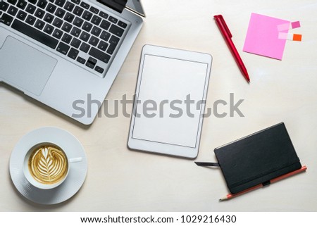 Blank tablet screen with copy space for writing a message lying on office desk as flat lay from above