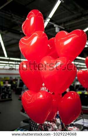 Red balloons in the form of hearts. Red balloons in the form of a heart fly under the ceiling. Red balloons in the form of a heart fly under the ceiling