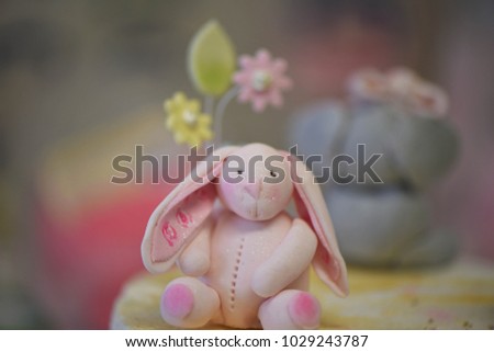 cute pink iced rabbit on top of a child's birthday cake