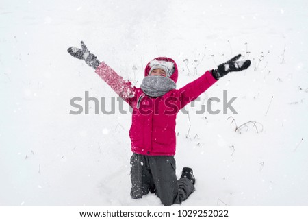 Happy girl playing in snow, winter games 