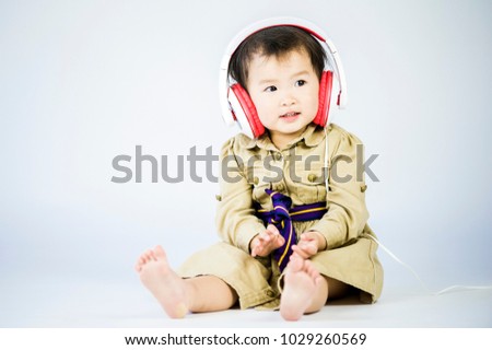 Children listen to music on a white background