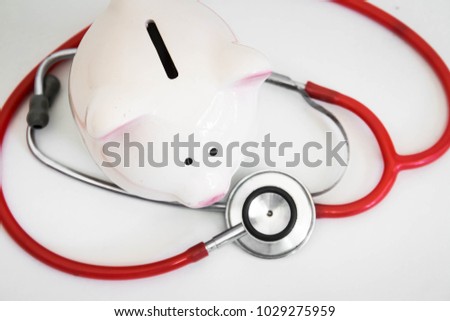 Piggy bank with stethoscope,Financial health Royalty-Free Stock Photo #1029275959