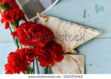 background for postcards by may 9, victory day: cap, letters, carnations and St. George ribbon Soviet icons and old photos