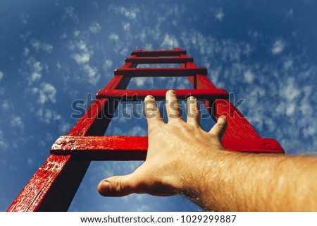 Development Motivation Career Growth Concept. Mans Hand Reaching For Red Ladder Leading To A Blue Sky