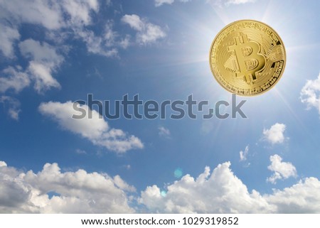 golden Bitcoin sun in the cloudy blue sky