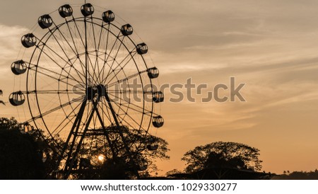 Ferris wheel with orange sky after sunset  