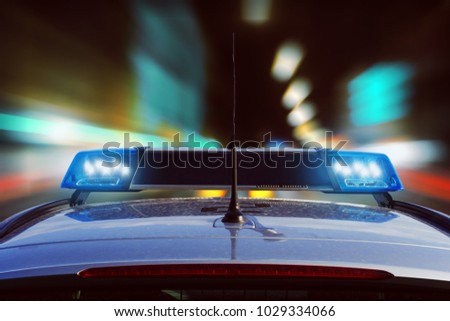 police car driving at night