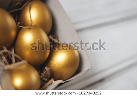 Golden Easter eggs in gift box copy space