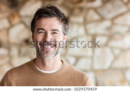 Portrait Of A Mature Man Smiling At The Camera. Home Royalty-Free Stock Photo #1029370459