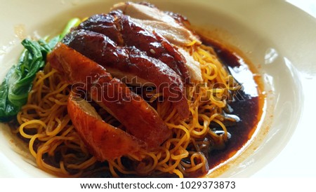 roasted crispy skin duck noodles, authentic hong kong traditional cuisine with yellow noodles and steamed vegetables, best asian food with soy sauce 
