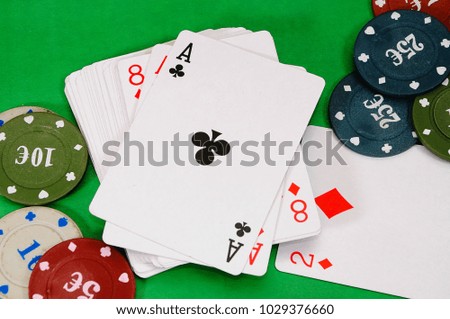 Poker chips with Royal Flush on a dark green background