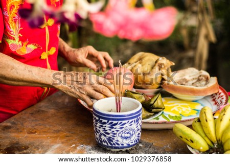 Hand of old woman sorting a food for pray and make offering. For luck In various events such as New Year, and a new home, ordained, and marriage.