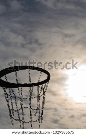 Basketball hoop and sunset sky on the background. Basketball ring