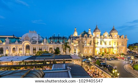 Grand Casino in Monte Carlo day to night transition timelapse, Monaco. Historical building aerial top view. Front view with entrance. Palm on the side.