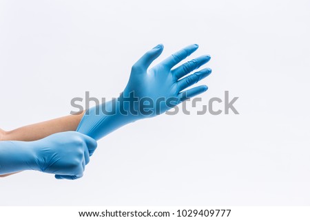Human holding Variation of Latex Glove, Rubber glove manufacturing, human hand is wearing a medical glove, glove, isolated Royalty-Free Stock Photo #1029409777