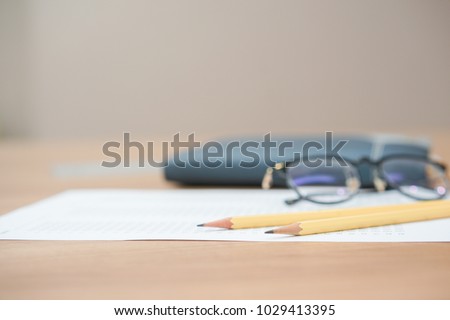 close up soft focus on pencil lay on notebook and exam test paper:blur picture concept.