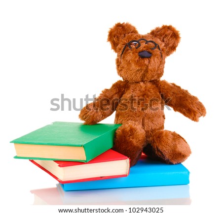 Sitting bear toy with books isolated on white