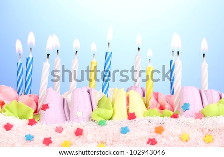 Birthday cake with candles on blue background
