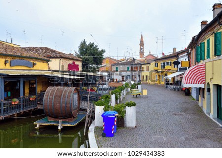 Small Italian town Comacchio also known as "The Little Venice", Emilia Romagna region, province of Ferrara, Italy: Colored houses in traditional architectural style
