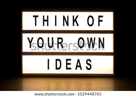Think about your own ideas light box sign board on wooden table. 