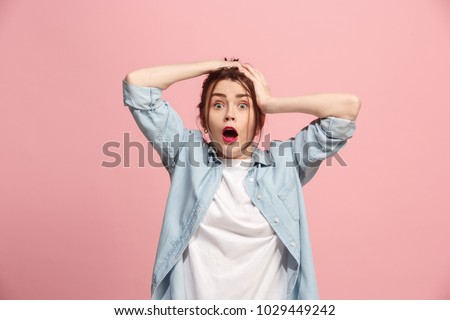 Horrible, stress, shock. Female half-length portrait isolated at pink studio. Young emotional surprised woman clasping head in hands. Human emotions, facial expression concept. Trendy colors. Front Royalty-Free Stock Photo #1029449242