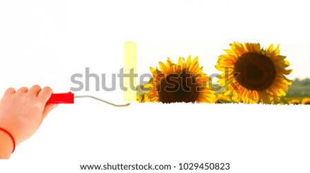 Person painting a landscape with sunflowers on a white wall with a roller brush
