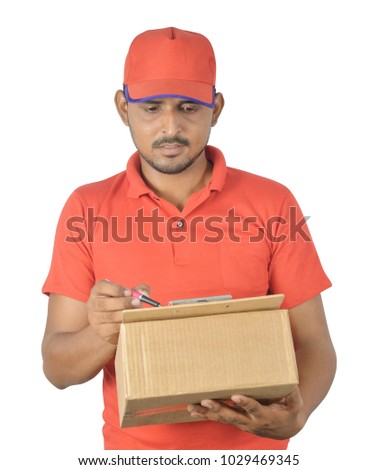 Handsome man holding carton box, checking list isolated on white background