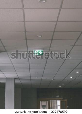 interior elements in large hall. green exit sign on the sealing - vintage retro look