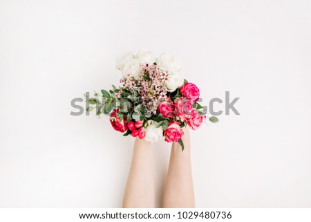Woman hands holding wedding flowers bouquet with roses, eucalyptus branch, wildflowers. Flat lay, top view wedding background.