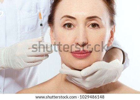 Face injection. Collagen, plastic surgery background concept. Isolated. Doctor hands