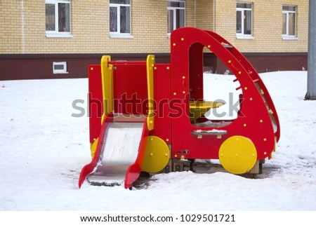 Children's playground, swings for children.  Winter city yard.