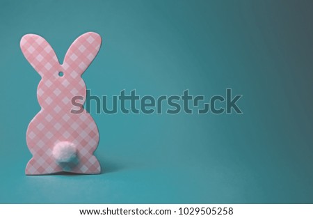 Cardboard Easter bunny on color background