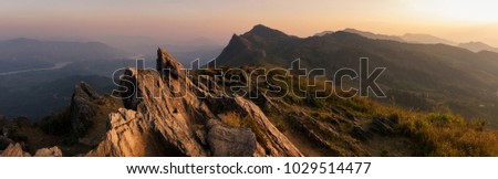 Panorama Mountain landscape with sunset on (Doi Pha Tang) viewpoint, Chiang Rai Thailand. Doi Pha Tang offers the best spot to watch the scenic Mekong river at the hilltop.