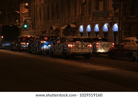 cars stuck in traffic in the winter evening city