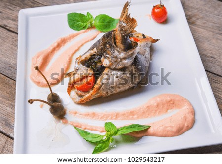 A dish of baked flounder stuffed with vegetables