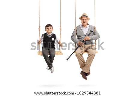 Little schoolboy and a mature man seated on swings isolated on white background Royalty-Free Stock Photo #1029544381