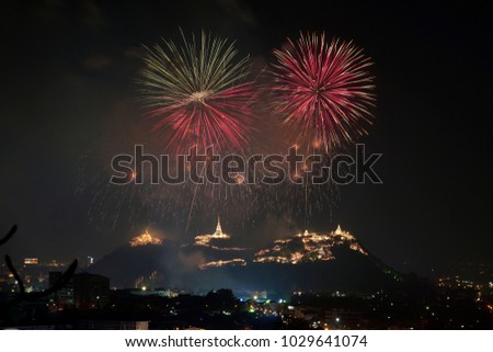 Firework is exploding over Buddha temple with beautiful night light in Thailand