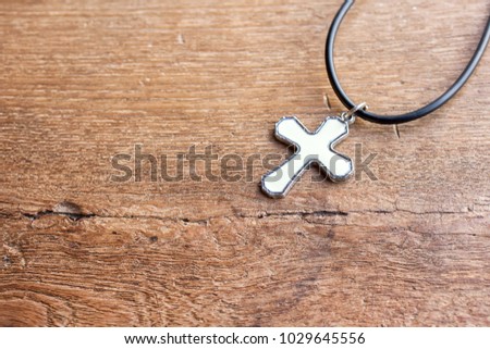 Christian cross on wooden table with window light, christian concept Jesus is the light of the world, Copy space for design