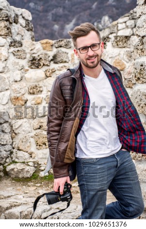 Portrait of a handsome amateur photographer while traveling