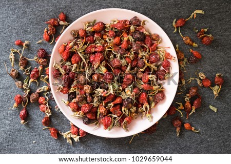 Dried ripe rose hip fruit. Antioxidant, source of vitamin C, immunity protection used during cold winter time with herbal tea. Organic farm product. Raw vegan vegetarian healthy food concept. Royalty-Free Stock Photo #1029659044