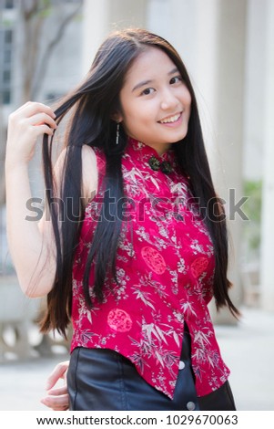 Portrait of thai teen beautiful girl in Chinese dress, relax and smile.