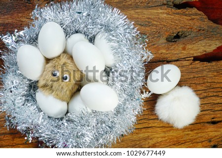 Happy Easter Day concept. Cartoon rabbit with eggs in nest and free space for text.