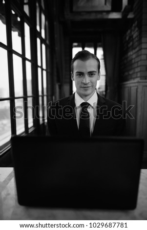 Portrait of young businessman exploring the city of Bangkok, Thailand in black and white