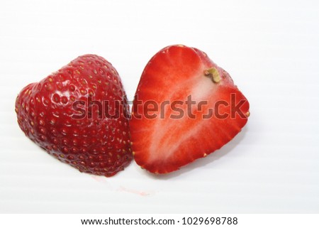 Strawberry cut look like  heart. On a white background