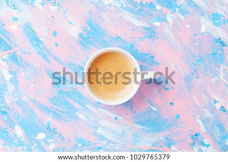 Coffee or cappuccino on punchy pastel table top view. Flat lay style.  Royalty-Free Stock Photo #1029765379