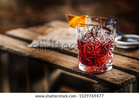 Cocktail Negroni on a old  wooden board. Drink with gin, campari martini rosso and orange. Royalty-Free Stock Photo #1029769477